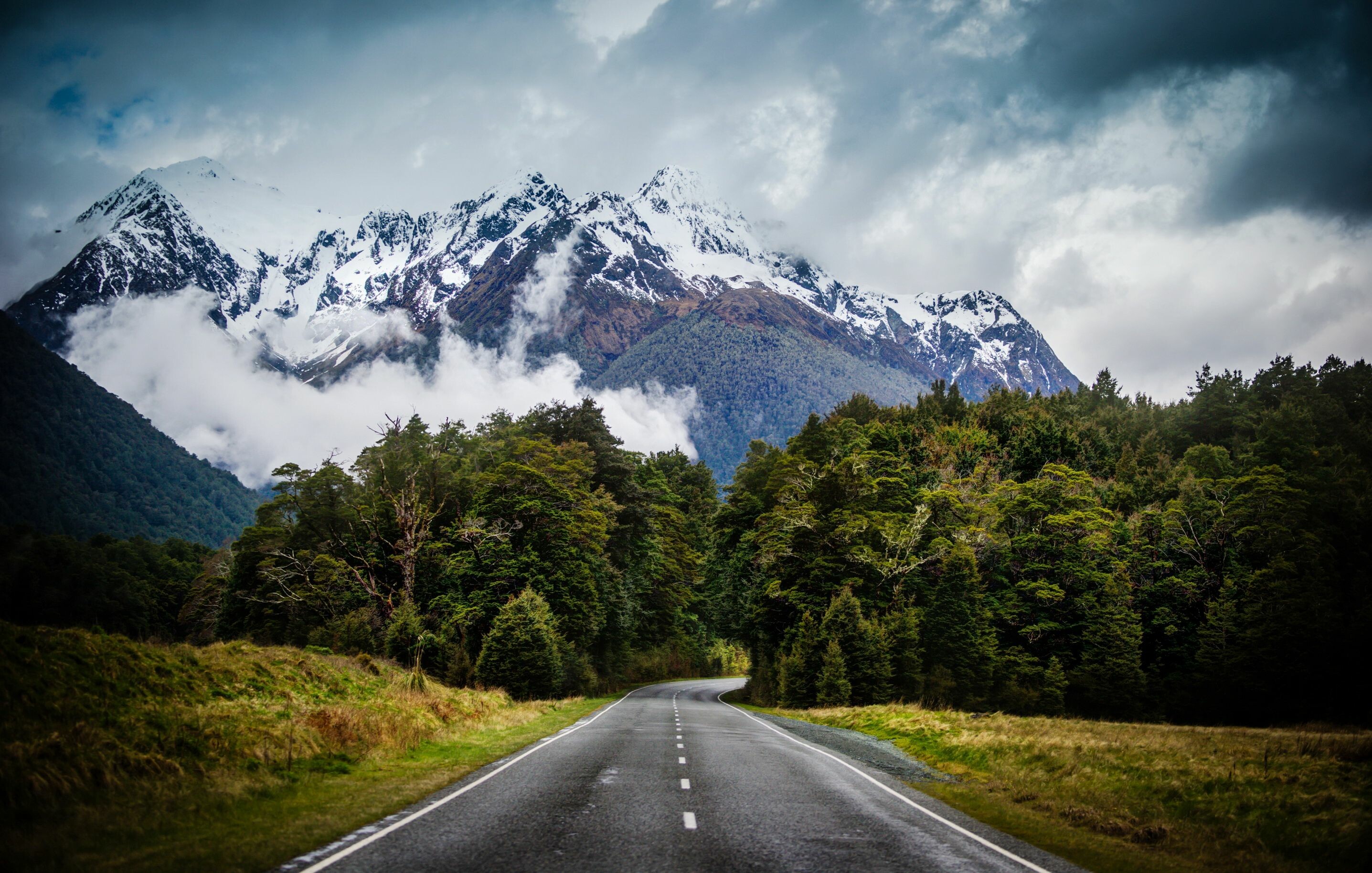 Landscape Of New Zealand Country Road Yellowed Grass, Rocky Peaks Of  Mountains With Snow, Dark Clouds Desktop Wallpaper Full Screen :  Wallpapers13.com