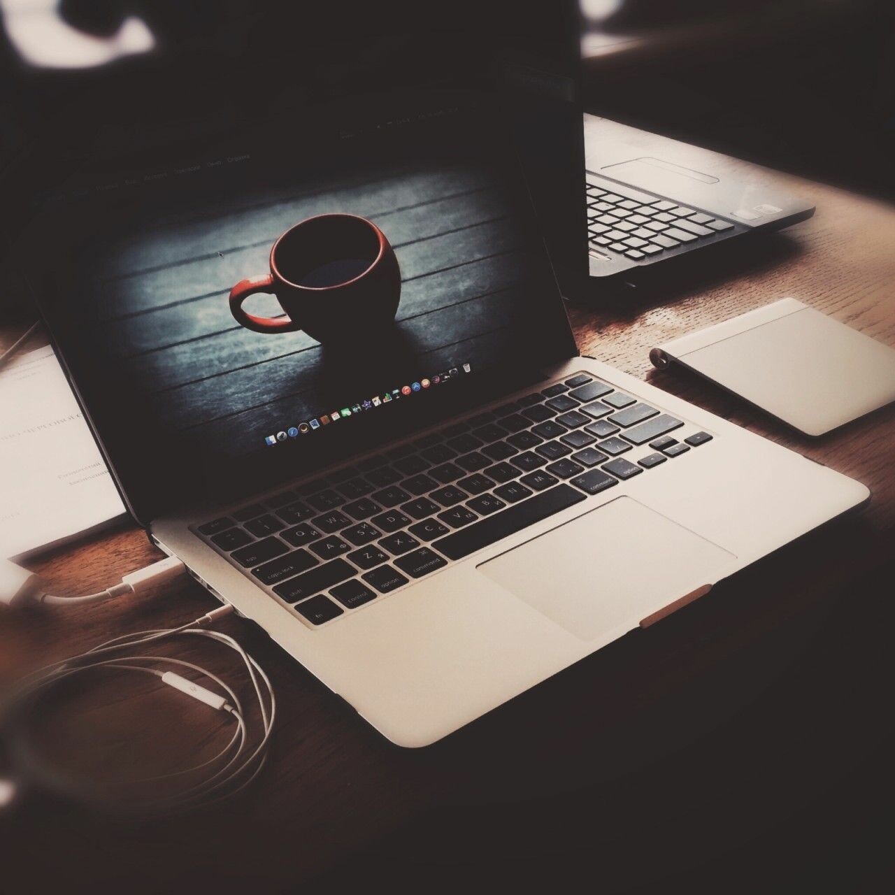 Cup of black coffee by laptop on black background - Stock Photo - Dissolve